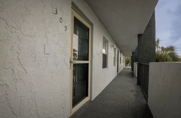 a dining room with wooden floor a chandelier a wooden table and chairs
