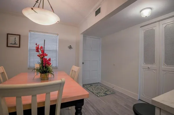 a kitchen with a refrigerator and a stove top oven