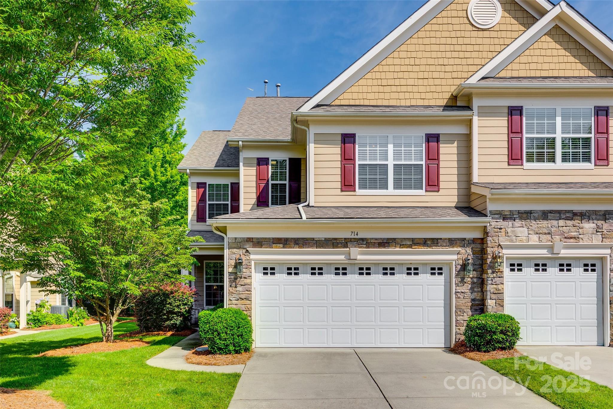 714 Deerbrook Lane Tega Cay, SC 29708 - Photo 1 of 35 a front view of a house with a garden and plants