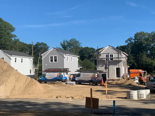 a front view of houses with yard