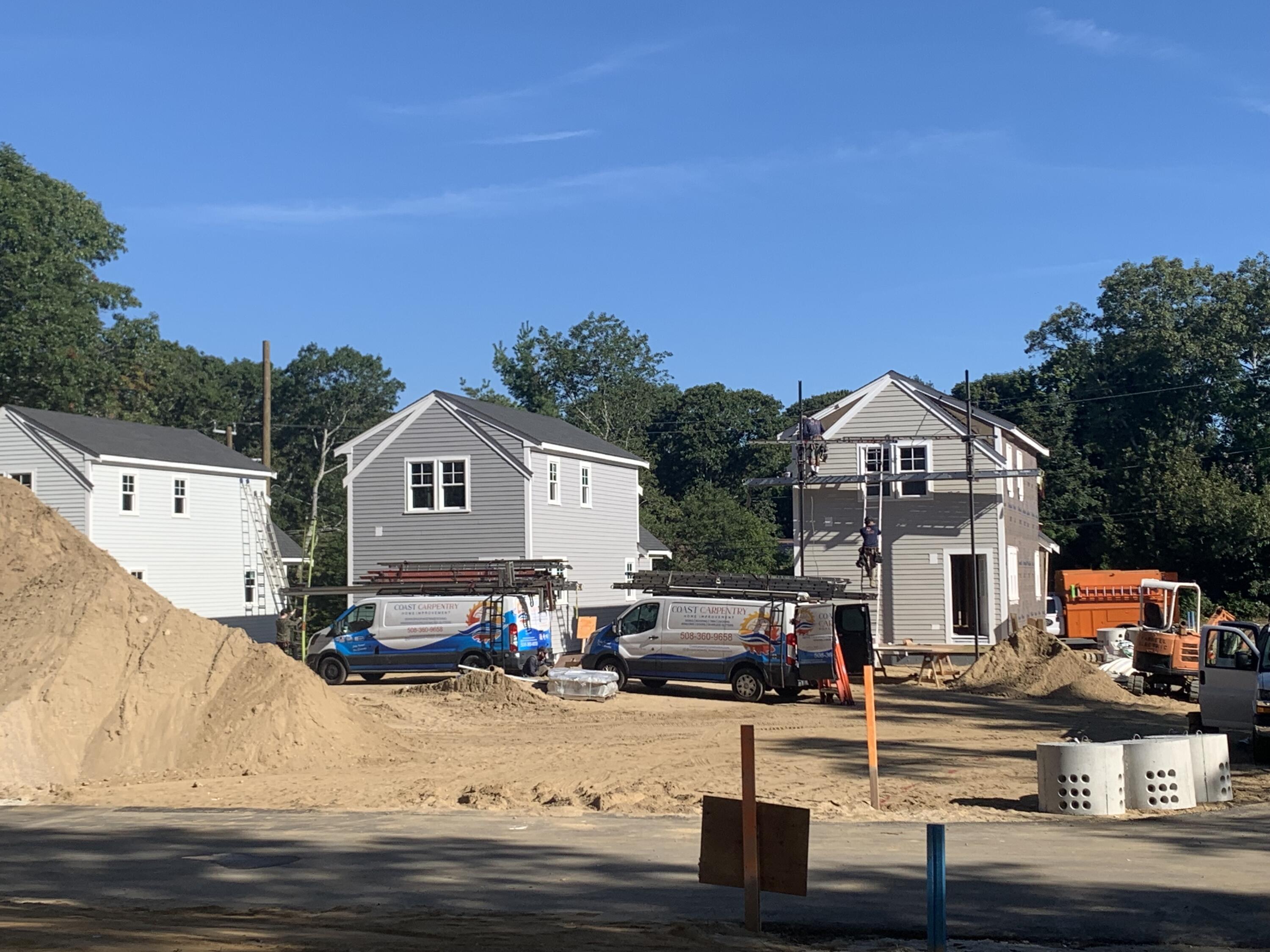 a front view of houses with yard