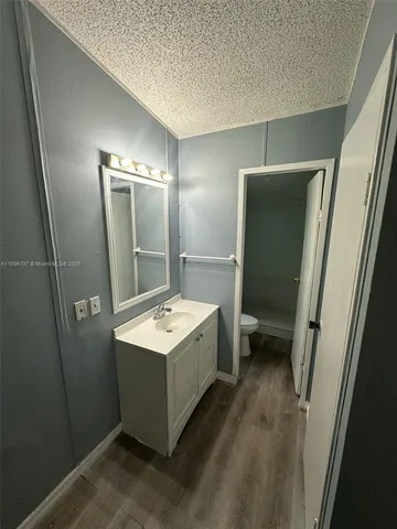 a bathroom with a sink a toilet and mirror