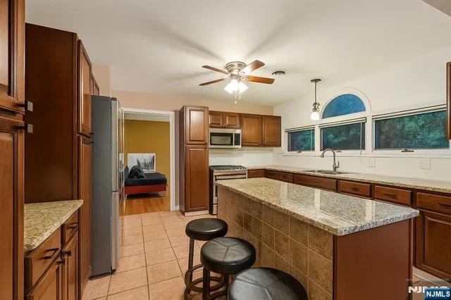 a kitchen with a stove a refrigerator and a sink