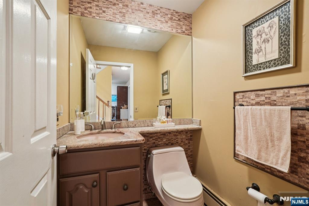 47 Matthew Road Wayne, NJ 07470 - Photo 13 of 25 a bathroom with a toilet a sink and mirror
