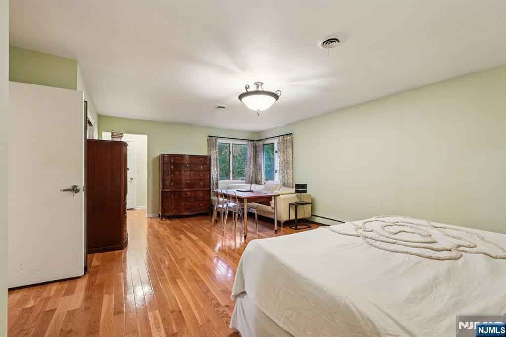 47 Matthew Road Wayne, NJ 07470 - Photo 14 of 25 a bedroom with a bed and a chandelier