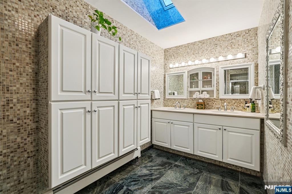 47 Matthew Road Wayne, NJ 07470 - Photo 17 of 25 a bathroom with a sink and a mirror