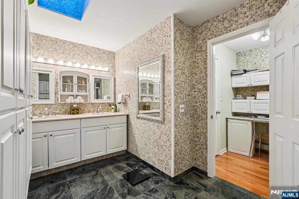 47 Matthew Road Wayne, NJ 07470 - Photo 18 of 25 a bathroom with a double vanity sink and mirror