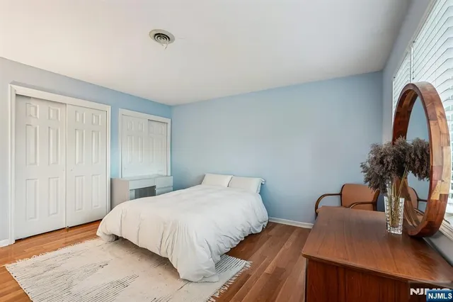 a bedroom with a bed and a potted plant