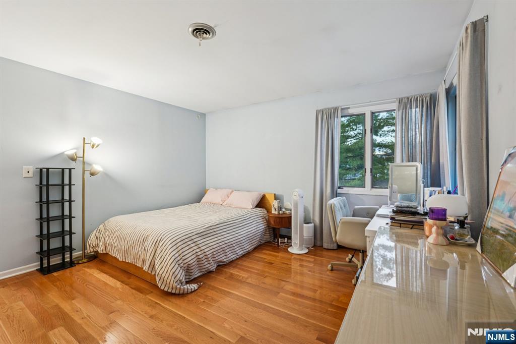 47 Matthew Road Wayne, NJ 07470 - Photo 20 of 25 a bedroom with a bed couch and a large window