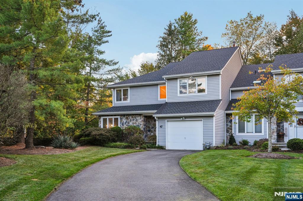 47 Matthew Road Wayne, NJ 07470 - Photo 2 of 25 a front view of a house with a yard and garage
