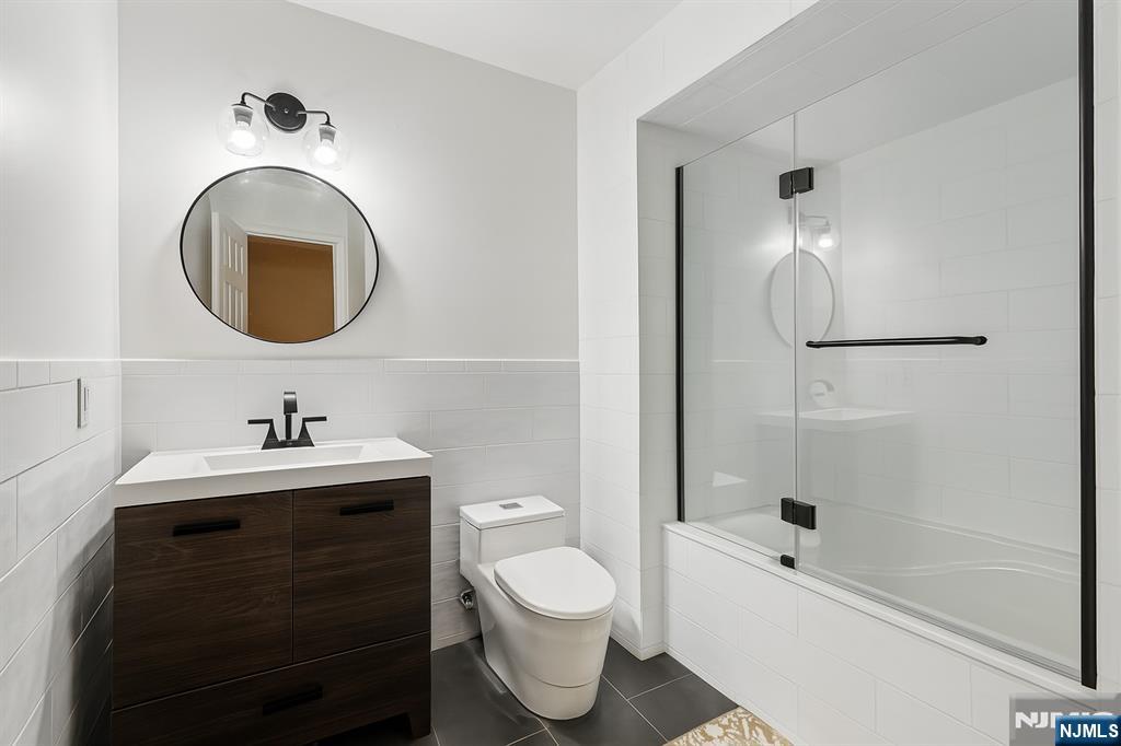 47 Matthew Road Wayne, NJ 07470 - Photo 21 of 25 a bathroom with a sink a toilet and a mirror