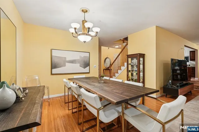 a view of a dining room with furniture wooden floor and chandelier