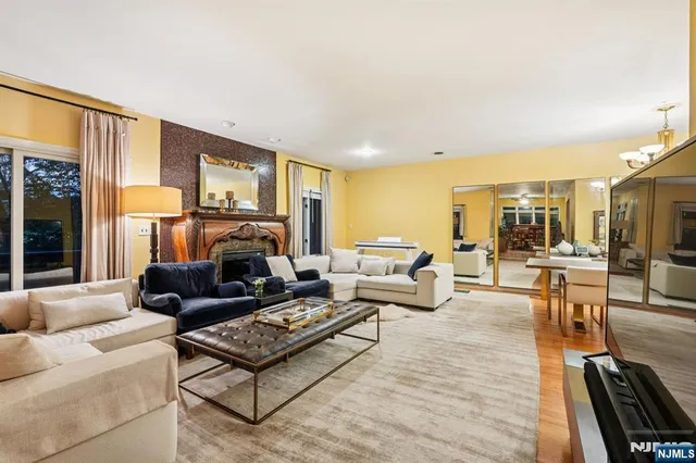 a living room with furniture a rug and a floor to ceiling window