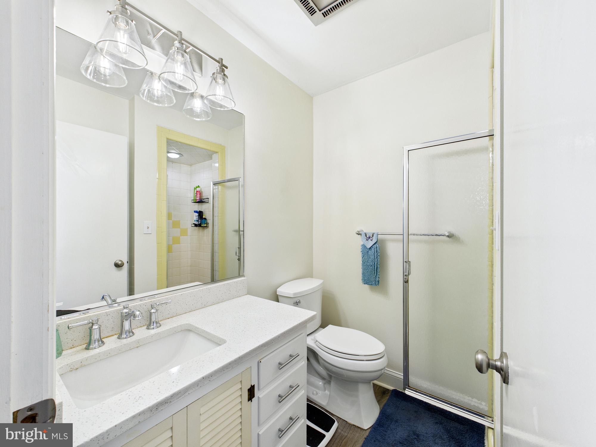 28964 Waller Road Delmar, MD 21875 - Photo 12 of 44 a bathroom with a granite countertop sink toilet a mirror and shower