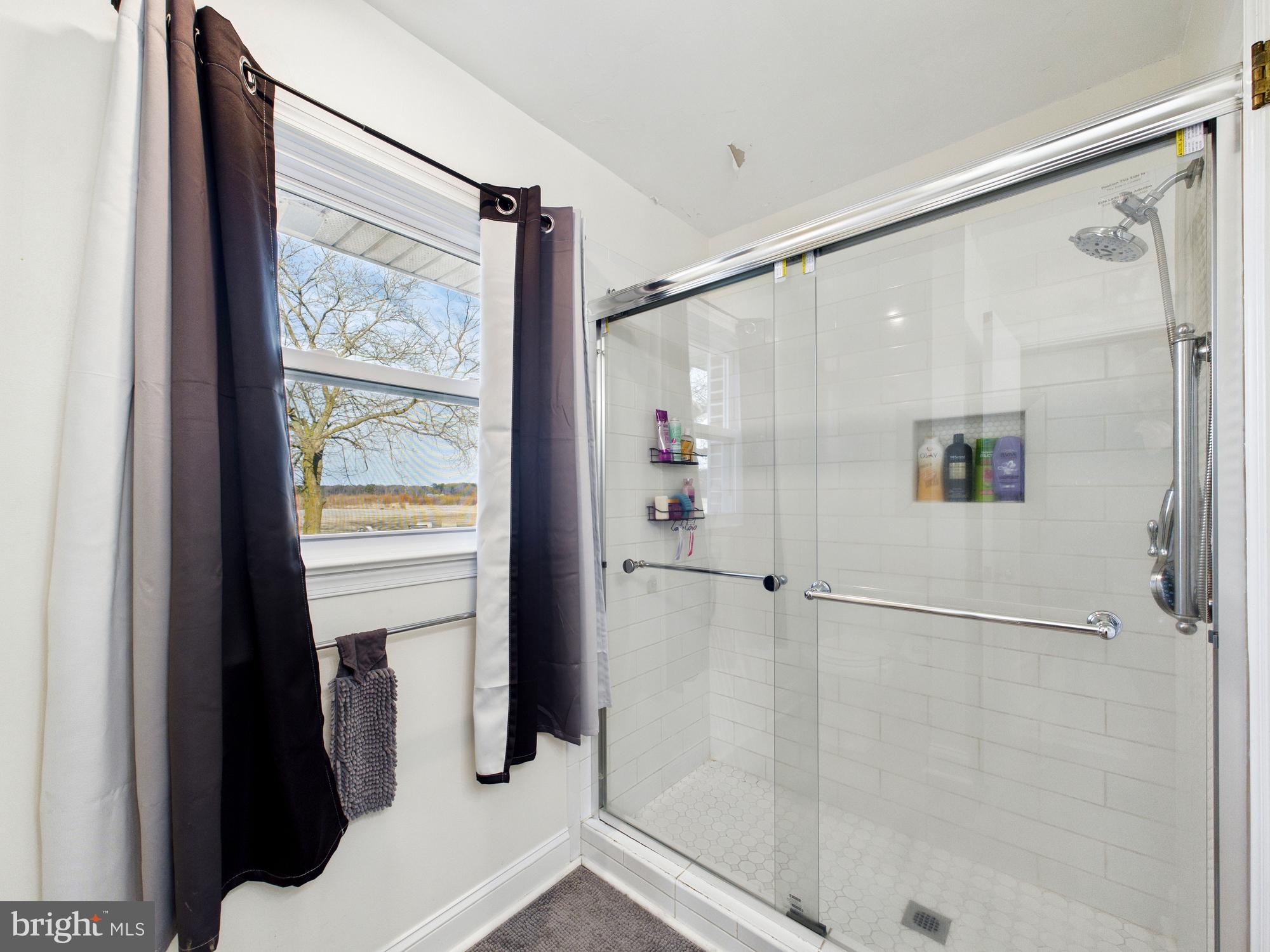 28964 Waller Road Delmar, MD 21875 - Photo 18 of 44 a bathroom with a shower and a window