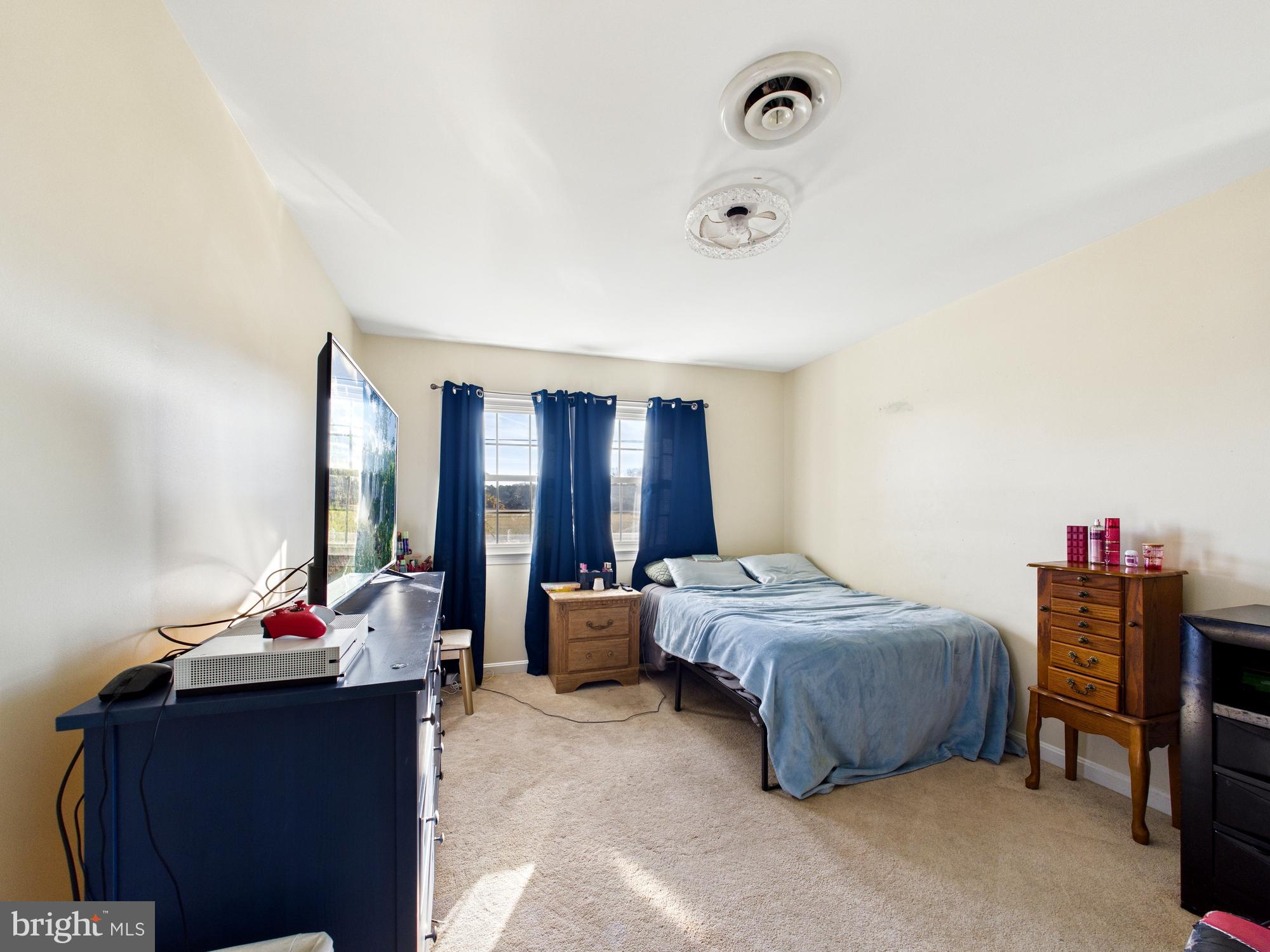 28964 Waller Road Delmar, MD 21875 - Photo 21 of 44 a bed room with a bed and a couch