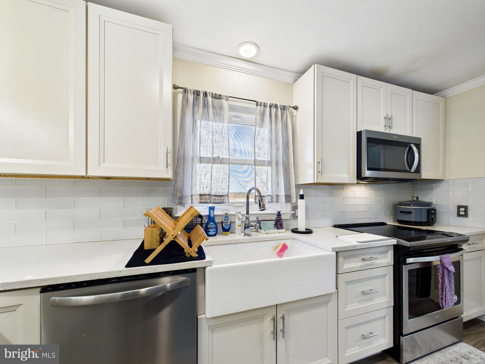 28964 Waller Road Delmar, MD 21875 - Photo 10 of 44 a utility room with stainless steel appliances white cabinets and a sink