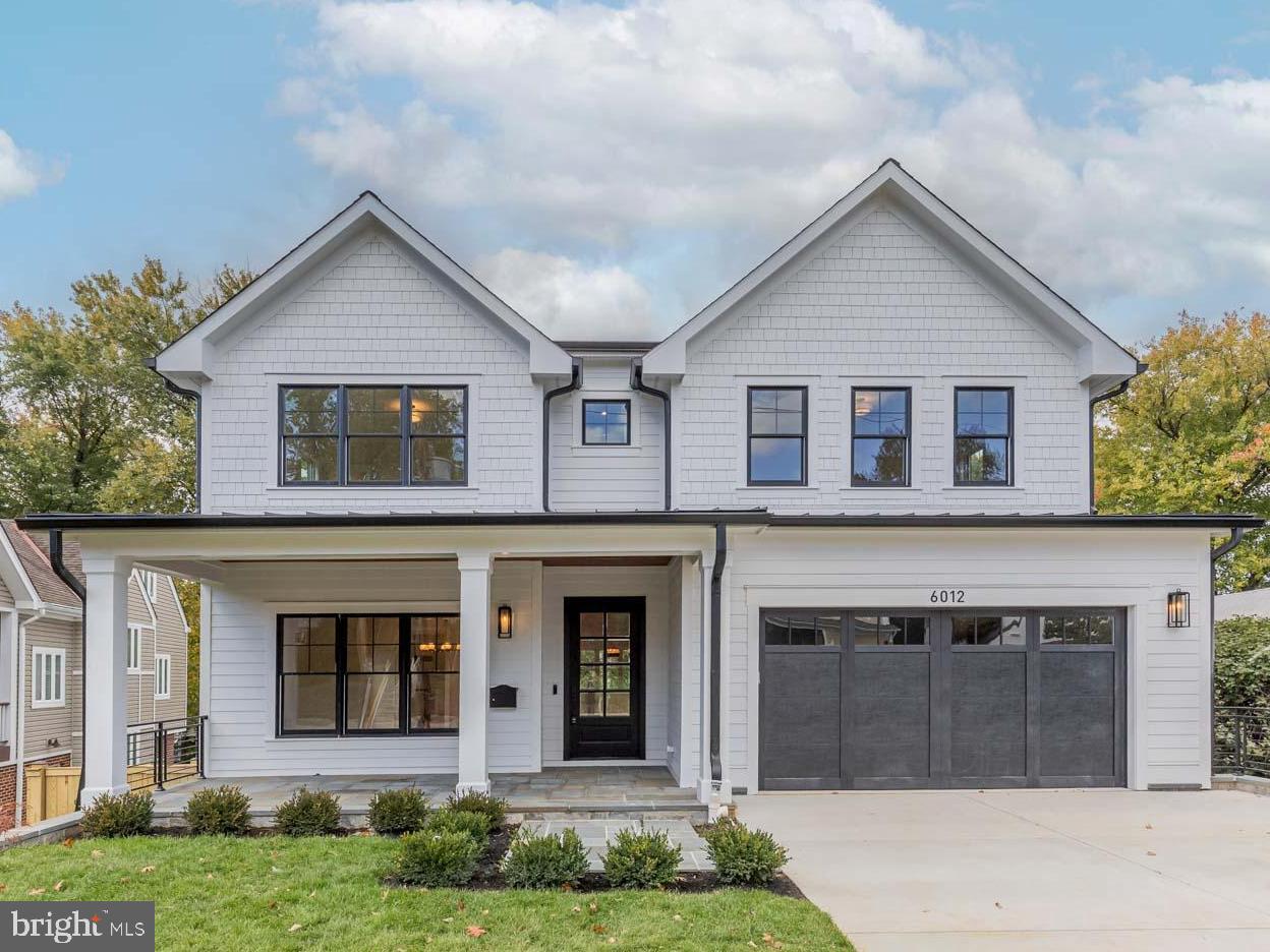 6012 Sonoma Road Bethesda, MD 20817 - Photo 1 of 57 a front view of a house with a yard and garage
