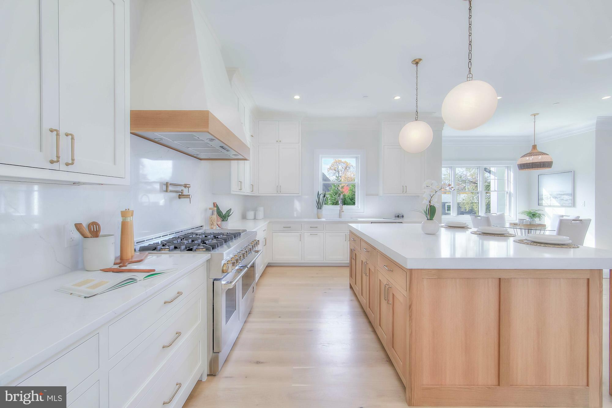 6012 Sonoma Road Bethesda, MD 20817 - Photo 11 of 57 a large kitchen with kitchen island white cabinets and a sink
