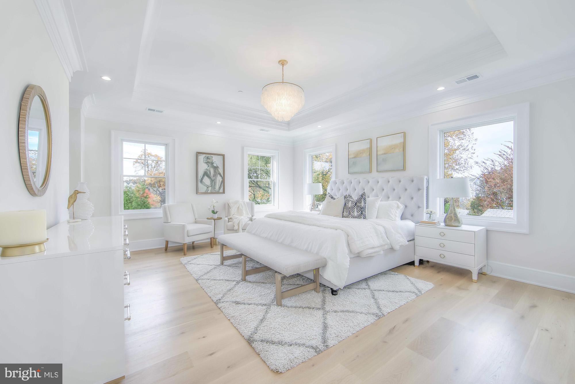 6012 Sonoma Road Bethesda, MD 20817 - Photo 21 of 57 a spacious bedroom with a large bed and a chandelier