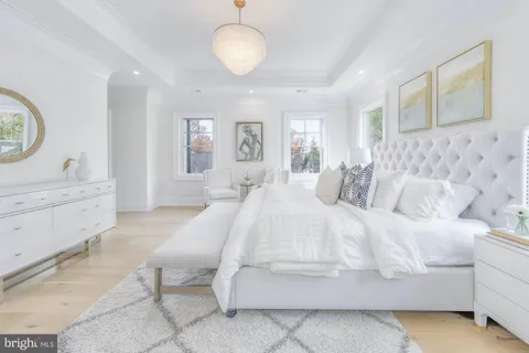 a white bath tub sitting in a bathroom next to a window