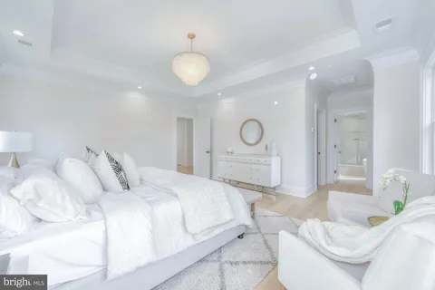 a living room with furniture a flat screen tv and a large window