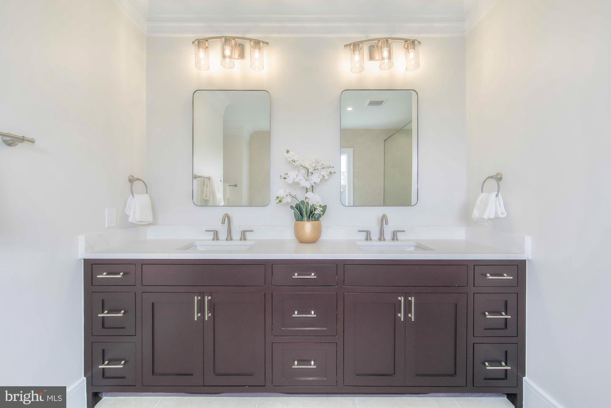 6012 Sonoma Road Bethesda, MD 20817 - Photo 25 of 57 a bathroom with a double vanity sink and mirror