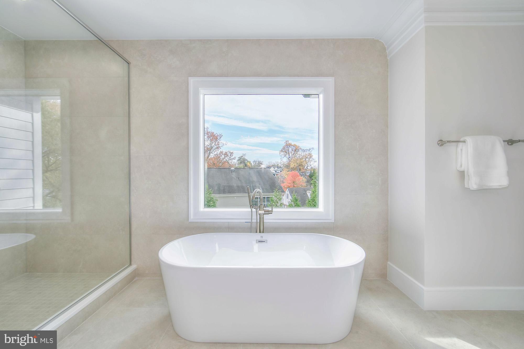 6012 Sonoma Road Bethesda, MD 20817 - Photo 26 of 57 a white bath tub sitting in a bathroom next to a window