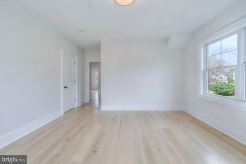 a view of room with window and hardwood floor