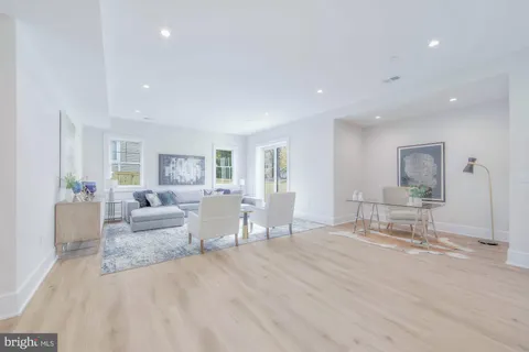 a view of entryway with furniture and wooden floor