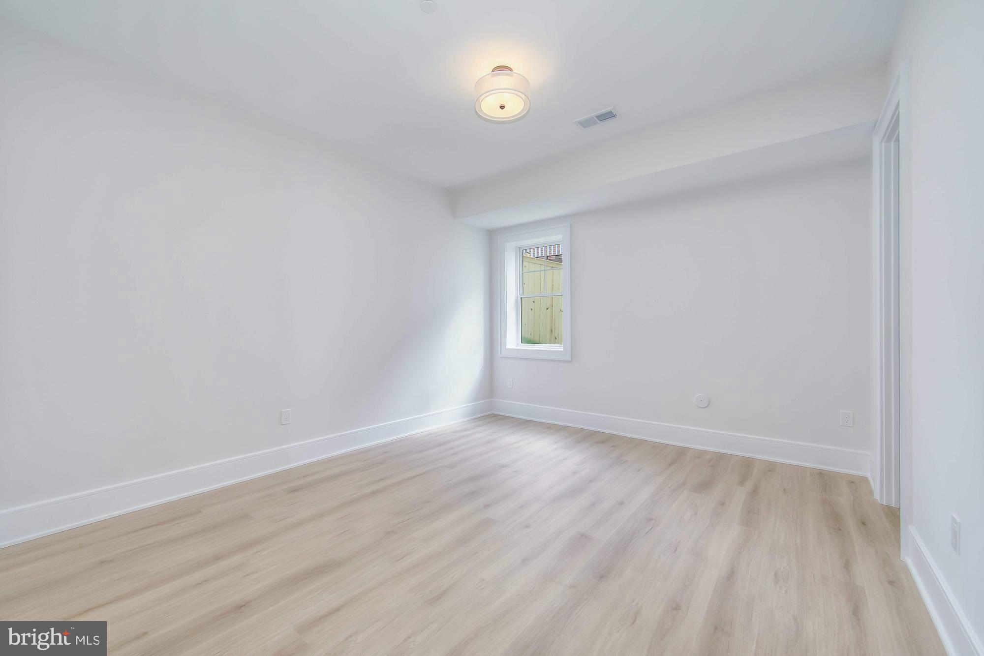 6012 Sonoma Road Bethesda, MD 20817 - Photo 44 of 57 an empty room with wooden floor and windows