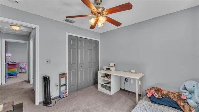 a bathroom with a sink vanity and toilet