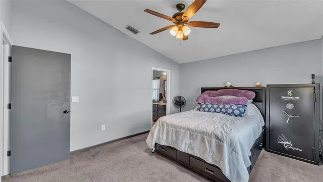 a bedroom with a large bed and a chandelier