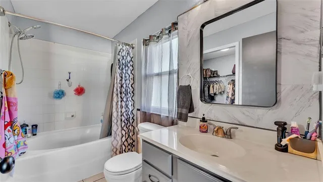 a view of walk in closet with clothes