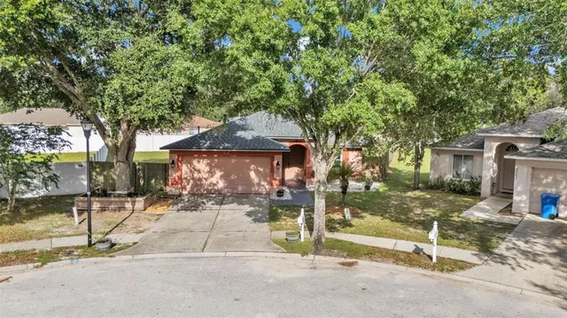 an aerial view of a house with a yard and lake view