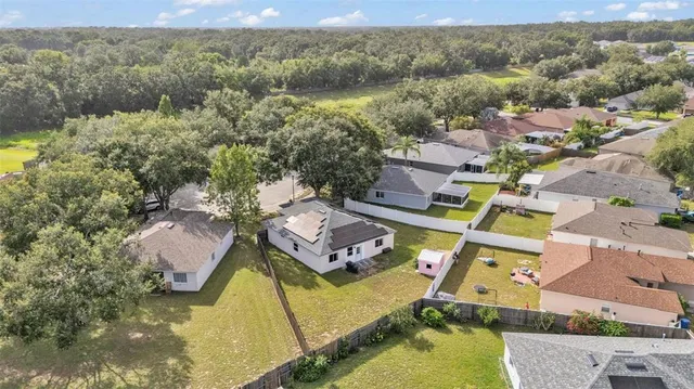 an aerial view of a house with a big yard