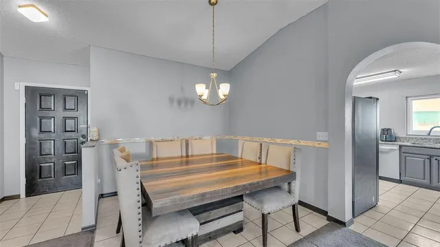 a view of a dining room with furniture and chandelier