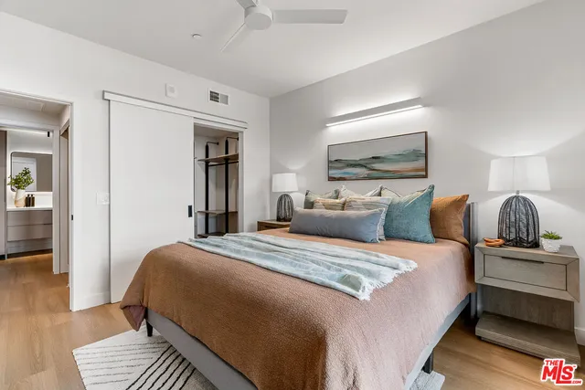 a bedroom with bed and wooden floor