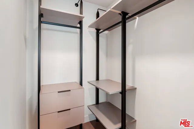 a view of a hallway with wooden floor and stairs