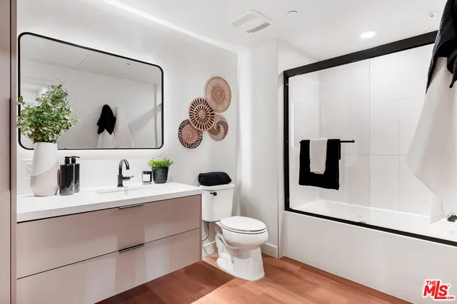 a bathroom with a toilet a sink and mirror