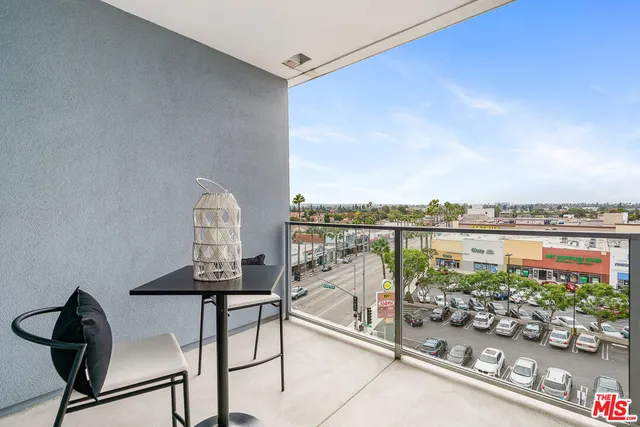 a view of a chairs and table in a balcony
