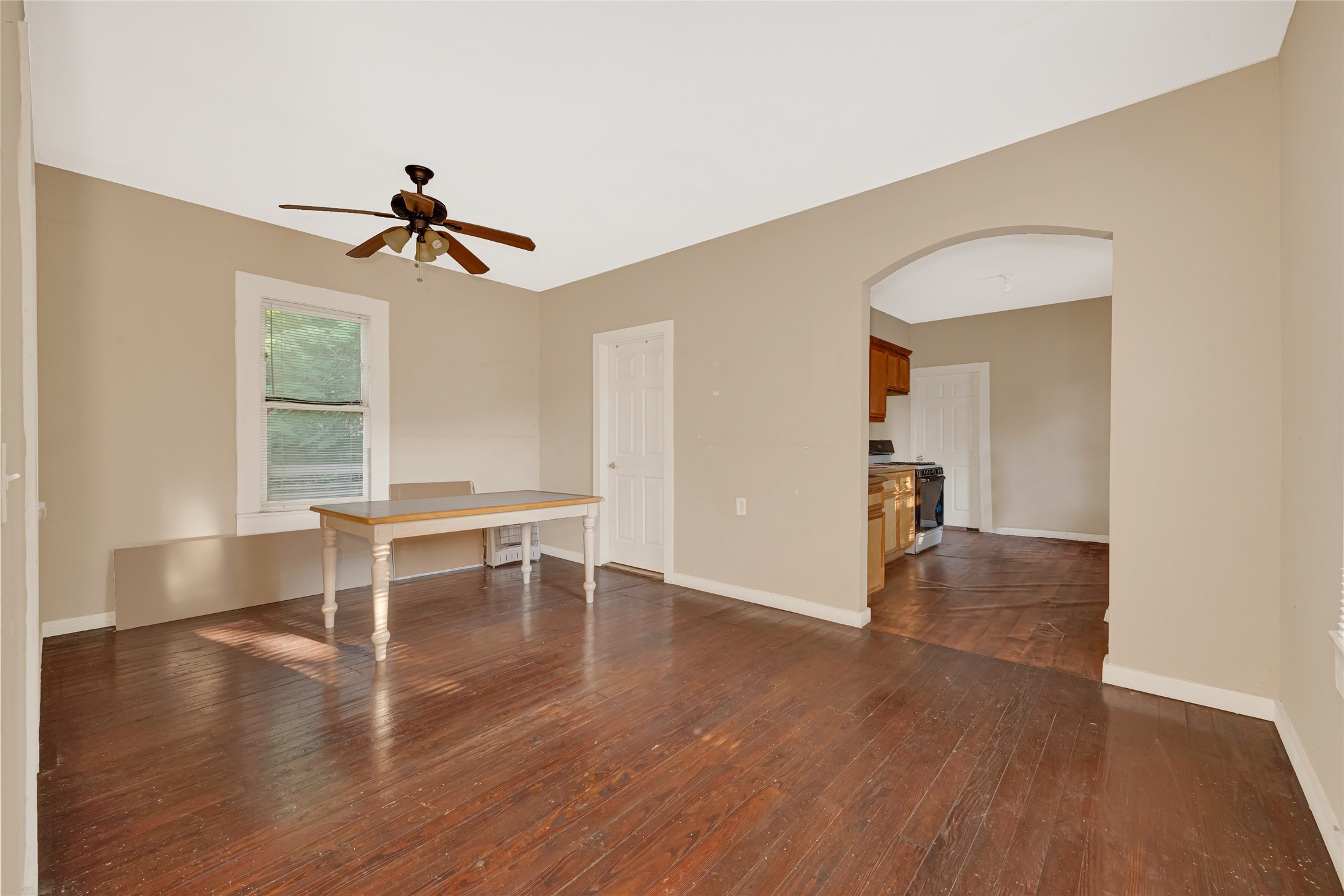 7305 Tremper Street Houston, TX 77020 - Photo 6 of 28 a view of a livingroom with wooden floor and a ceiling fan