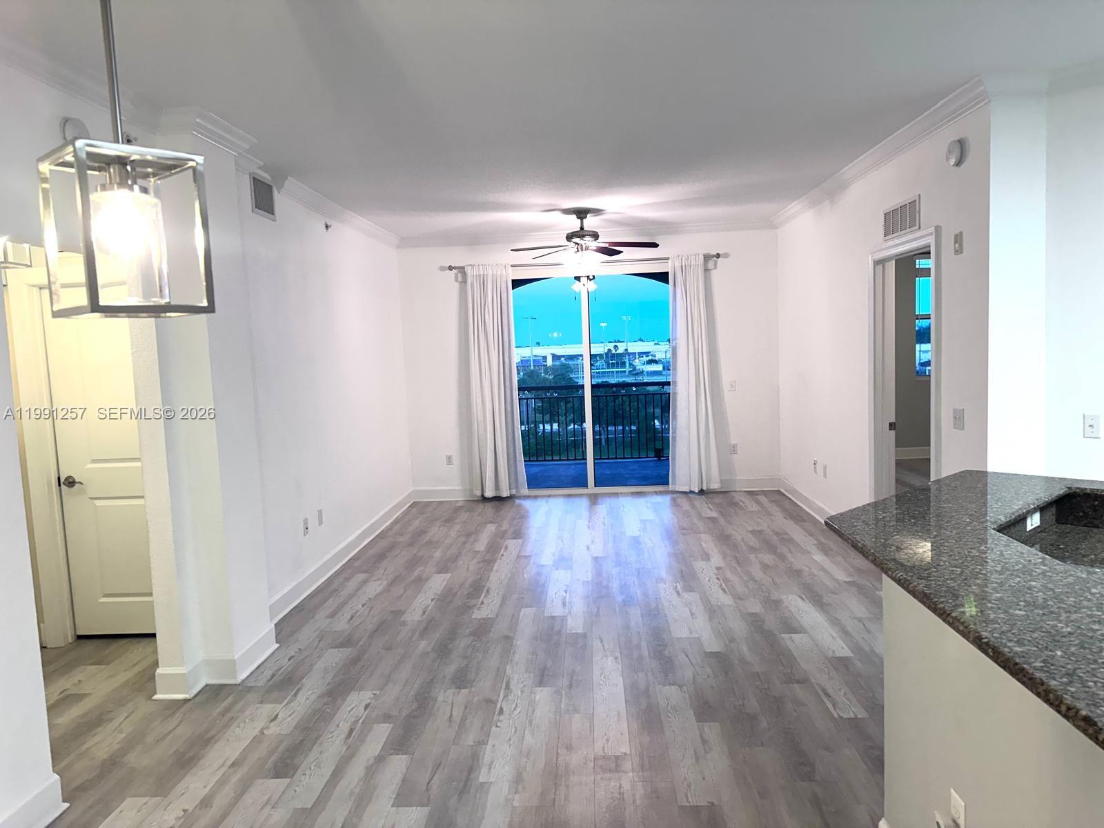 1660 Renaissance Commons Boulevard, Unit 2606 Boynton Beach, FL 33426 - Photo 10 of 26 wooden floor in an empty room with a window