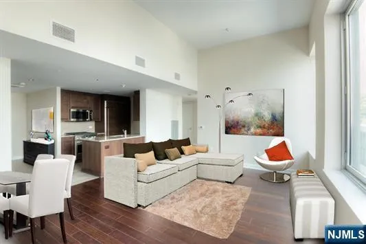 a living room with furniture window and a ceiling fan