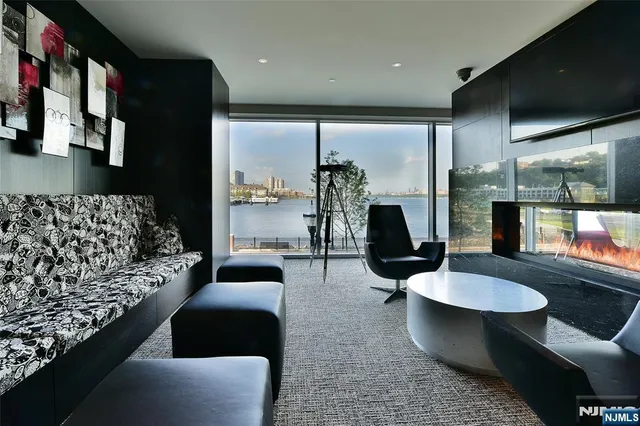 a work room with furniture and large windows