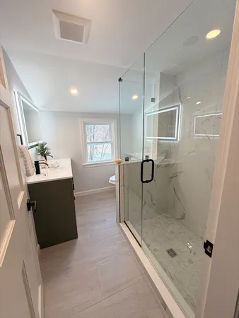 a bathroom with a glass shower door