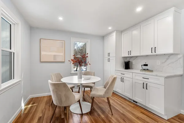 a view of a dining room with furniture and wooden floor