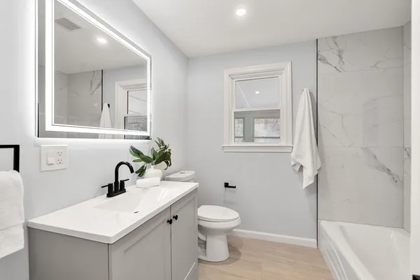 a bathroom with a sink toilet and shower