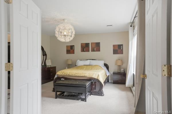 29 Hickory Hill Road Newburgh, NY 12550 - Photo 28 of 47 a bed room with a bed and a chandelier