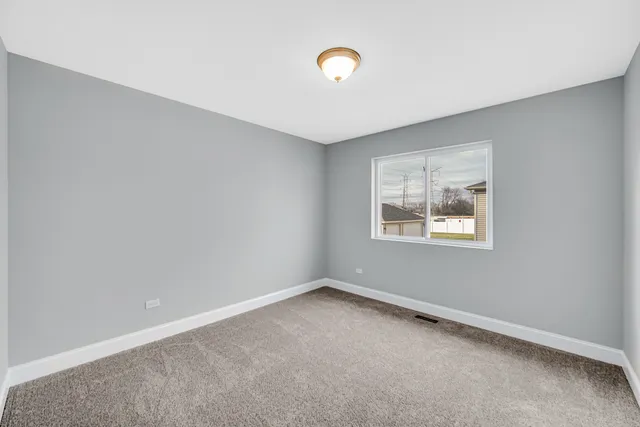 a view of a kitchen with wooden floor and windows